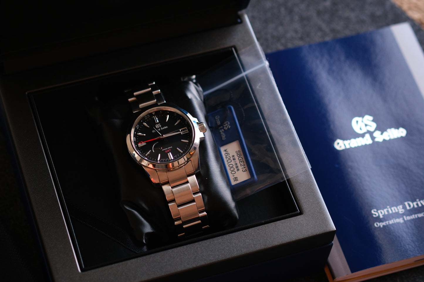 Grand Seiko SBGE213 9R66-0AE0 Spring Drive GMT Red Hands Black Dial Box Manual User Hang Tag Good Condition